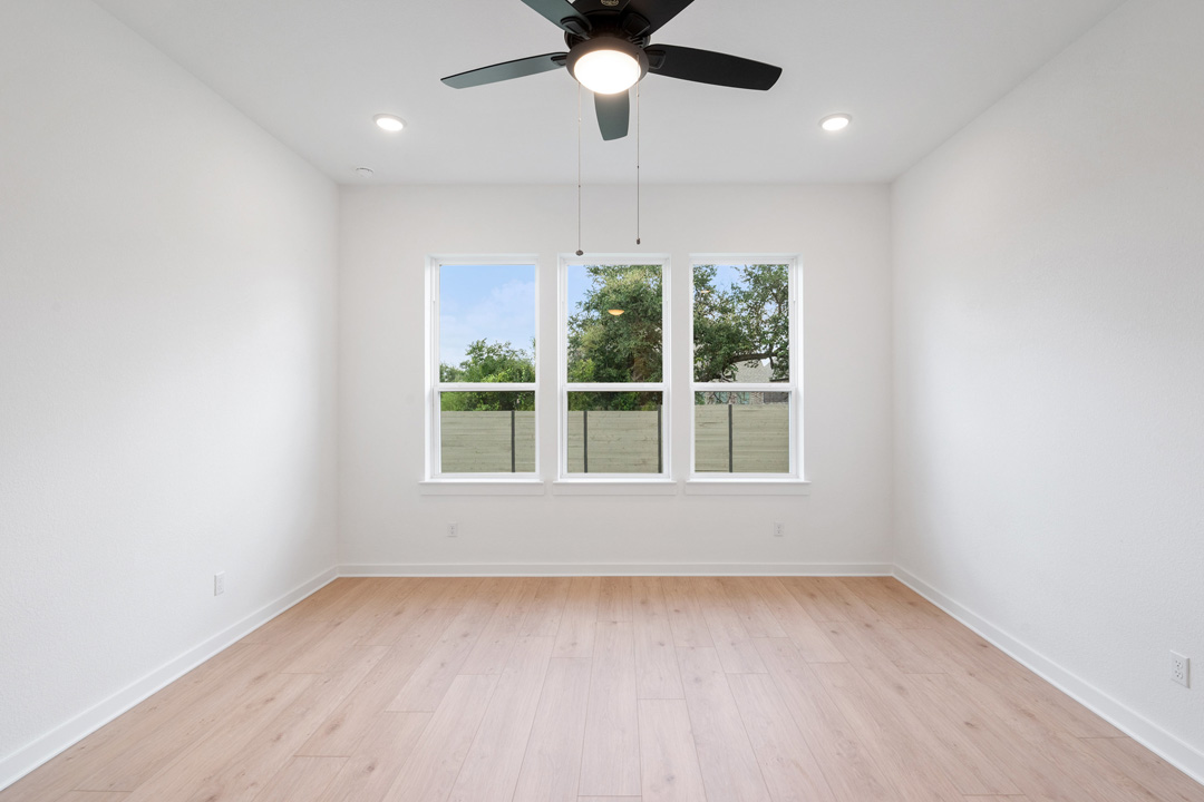 1114 Blue Moon Drive Georgetown, TX 78628 - Photo 23 of 39 an empty room with a window and a ceiling fan