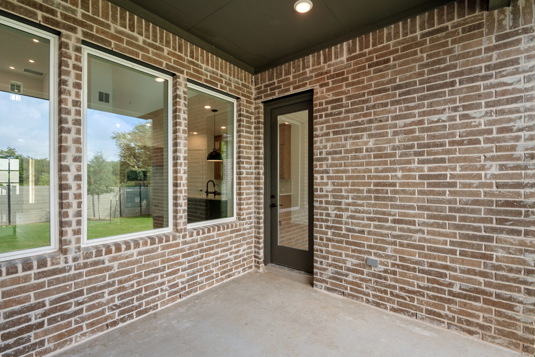 1114 Blue Moon Drive Georgetown, TX 78628 - Photo 34 of 39 a view of a brick house with large windows