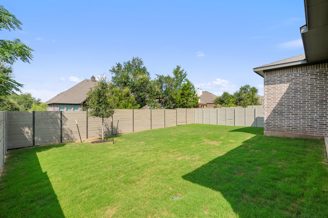 1114 Blue Moon Drive Georgetown, TX 78628 - Photo 35 of 39 a backyard of a house with plants and wooden fence