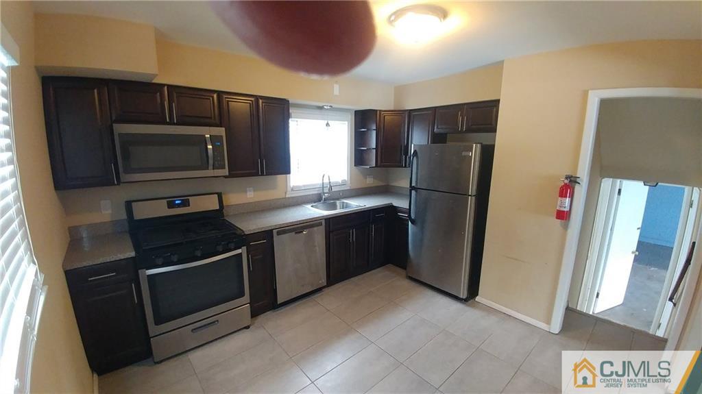 1019 Main Street Fords, NJ 08863 - Photo 2 of 13 a kitchen with a refrigerator sink and microwave