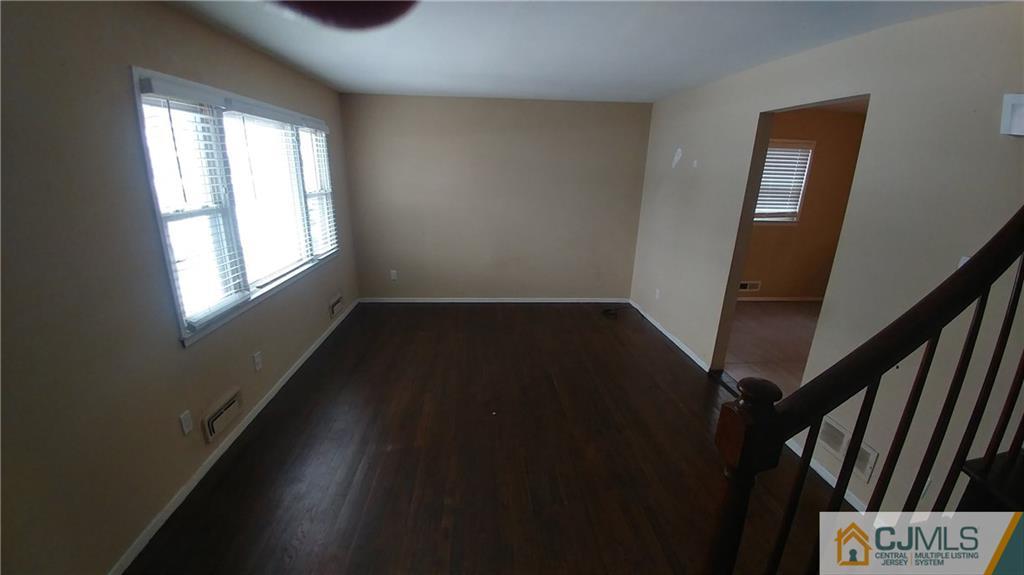 1019 Main Street Fords, NJ 08863 - Photo 5 of 13 a view of an empty room with wooden floor and a window