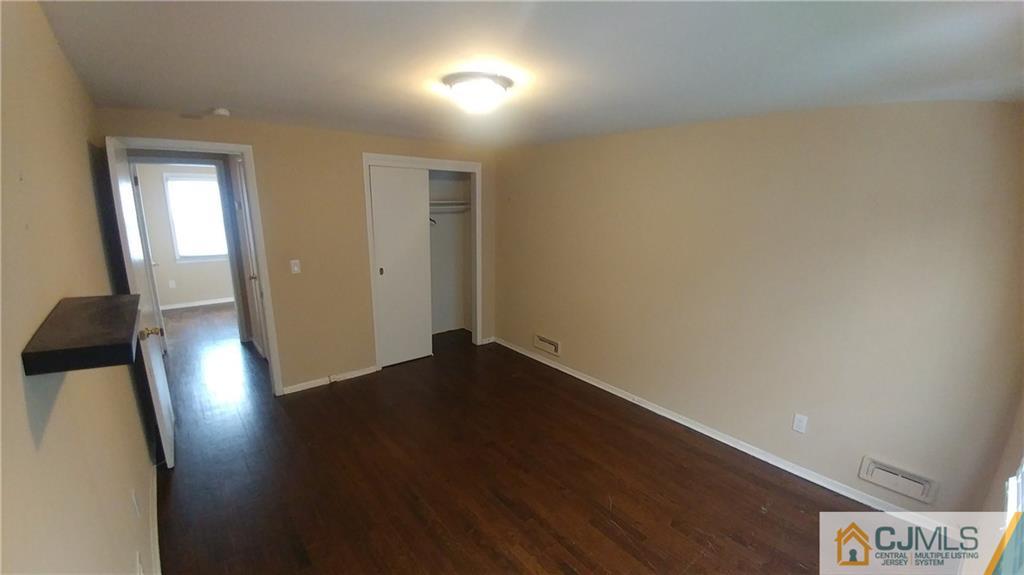 1019 Main Street Fords, NJ 08863 - Photo 8 of 13 an empty room with wooden floor and windows