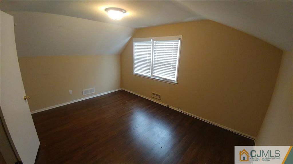 1019 Main Street Fords, NJ 08863 - Photo 9 of 13 an empty room with wooden floor and windows