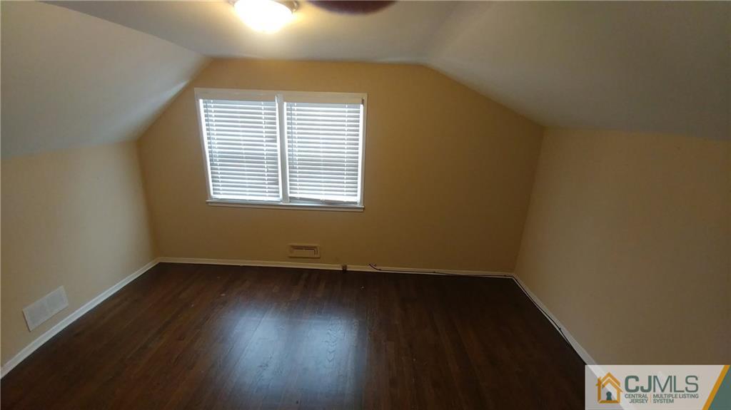 1019 Main Street Fords, NJ 08863 - Photo 10 of 13 an empty room with wooden floor and windows
