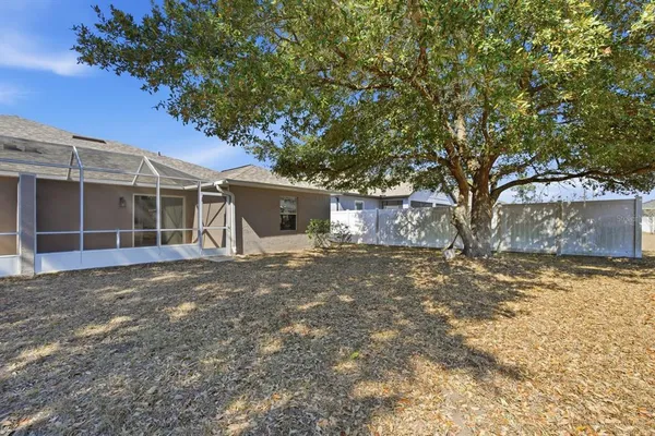 a front view of house with yard and trees