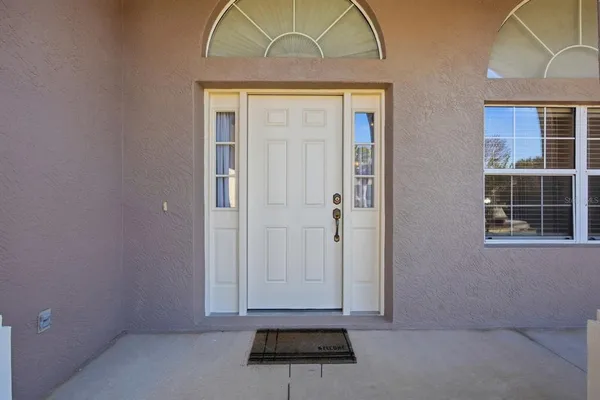 an empty room with cabinet and a chandelier fan