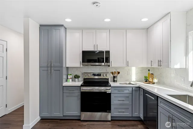 a kitchen with a sink stove and microwave