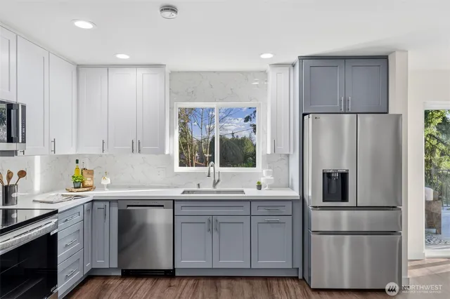 a kitchen with a refrigerator sink and cabinets