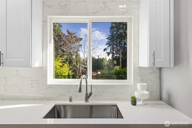 a kitchen with a window a sink and a counter top space