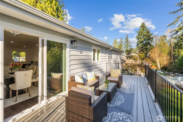 a view of a balcony with chairs and wooden floor