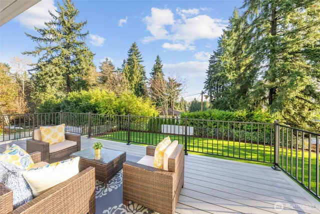 a view of a deck with couches table and chairs
