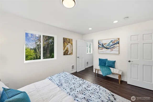 a bedroom with a bed and a window