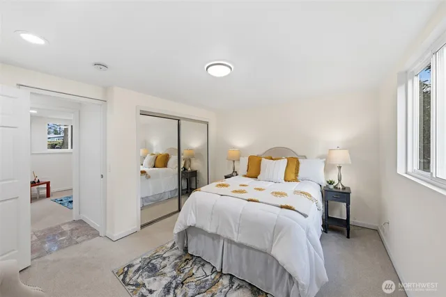 a bedroom with a bed and a mirror