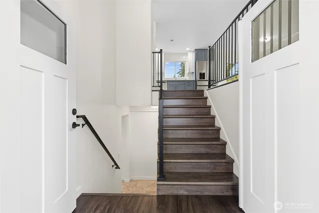 a view of entryway and hall with wooden floor