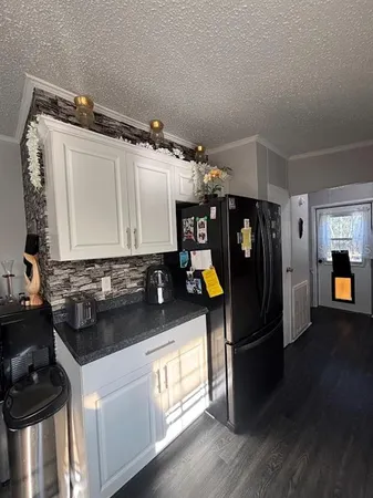 a kitchen with refrigerator and window