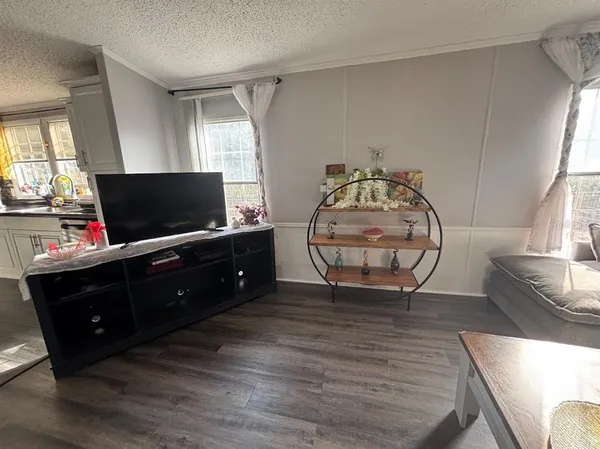 a living room with furniture and flat screen tv