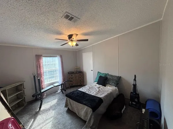 a bedroom with a bed and window
