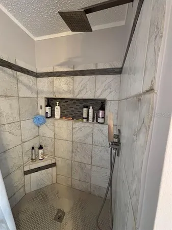 a bathroom with a granite countertop double vanity sink and a mirror