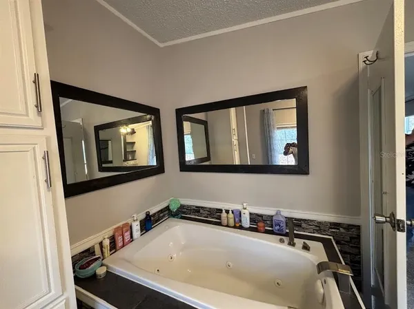 a bedroom with a bed and a ceiling fan