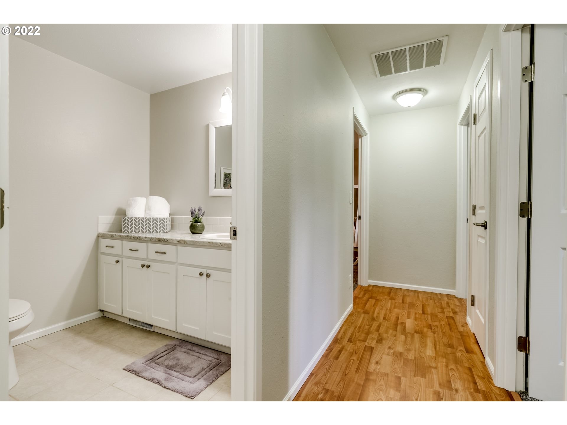 610 67th Place Springfield, OR 97478 - Photo 17 of 28 a bathroom with a granite countertop sink a mirror and a shower