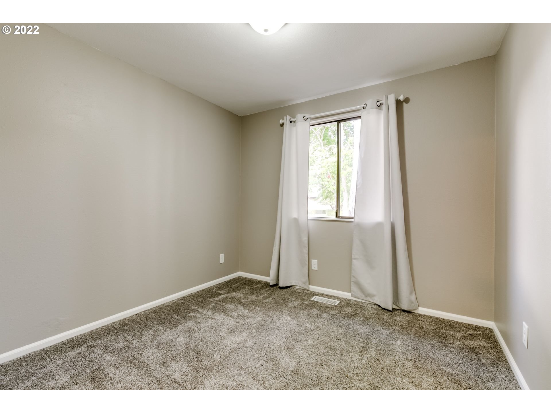 610 67th Place Springfield, OR 97478 - Photo 19 of 28 a view of an empty room with a window