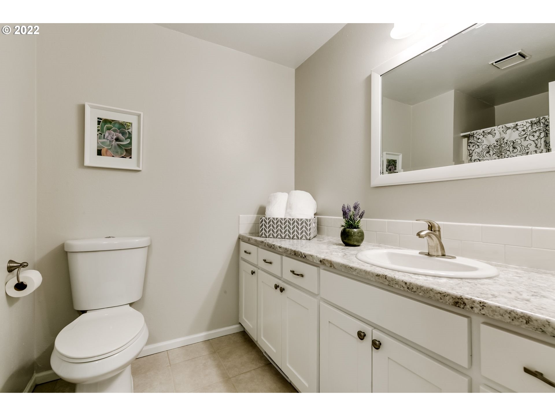 610 67th Place Springfield, OR 97478 - Photo 20 of 28 a bathroom with a granite countertop toilet sink and mirror