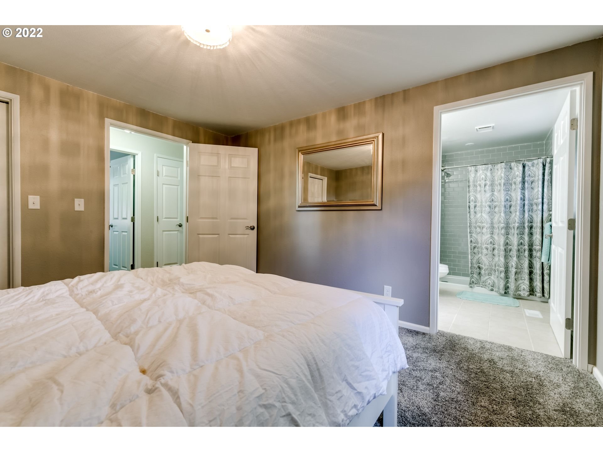 610 67th Place Springfield, OR 97478 - Photo 22 of 28 a bedroom with a bed and a painting on the wall