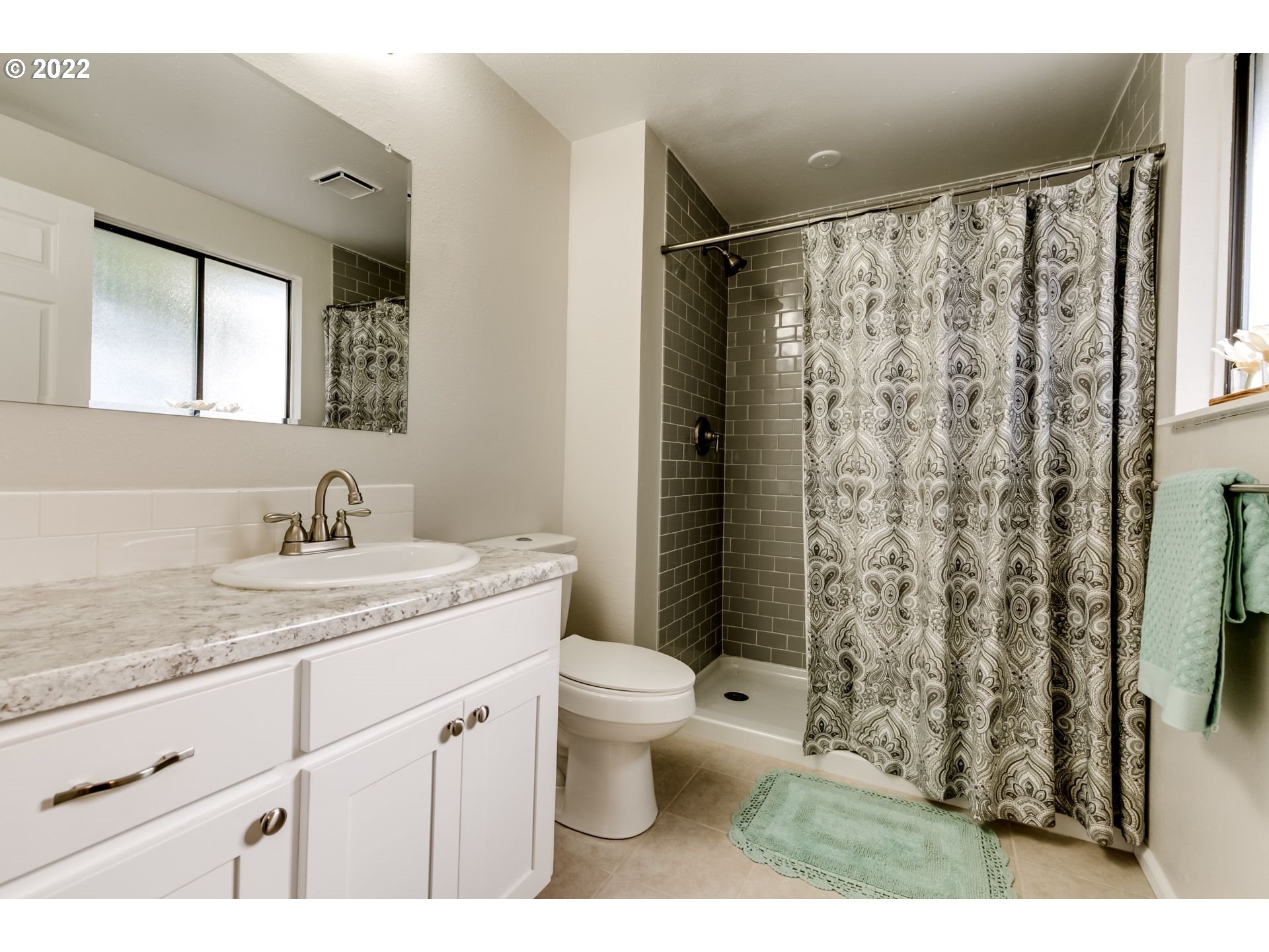 610 67th Place Springfield, OR 97478 - Photo 23 of 28 a bathroom with a granite countertop sink toilet and shower