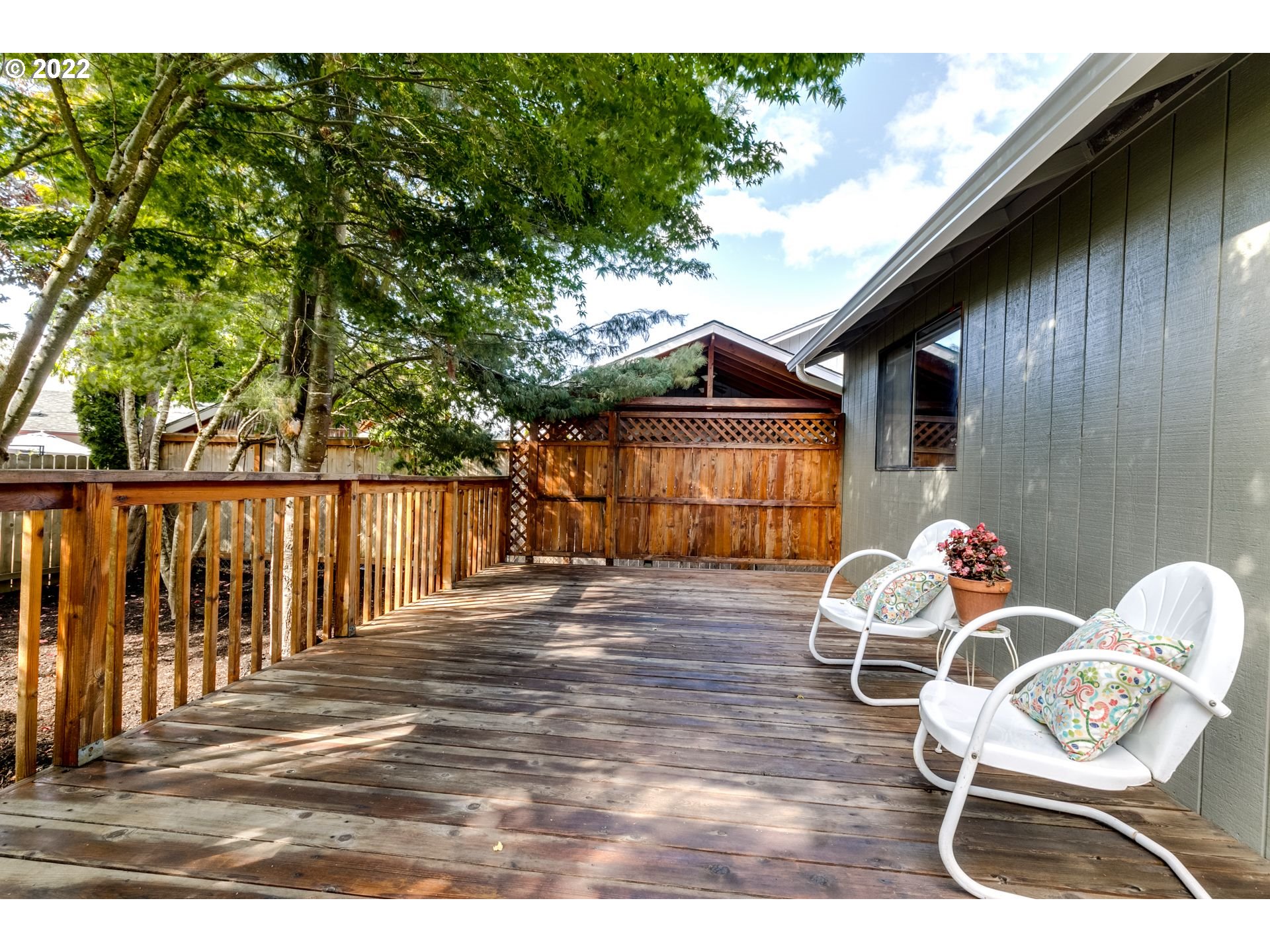 610 67th Place Springfield, OR 97478 - Photo 24 of 28 a backyard of a house with wooden barbeque oven table and chairs