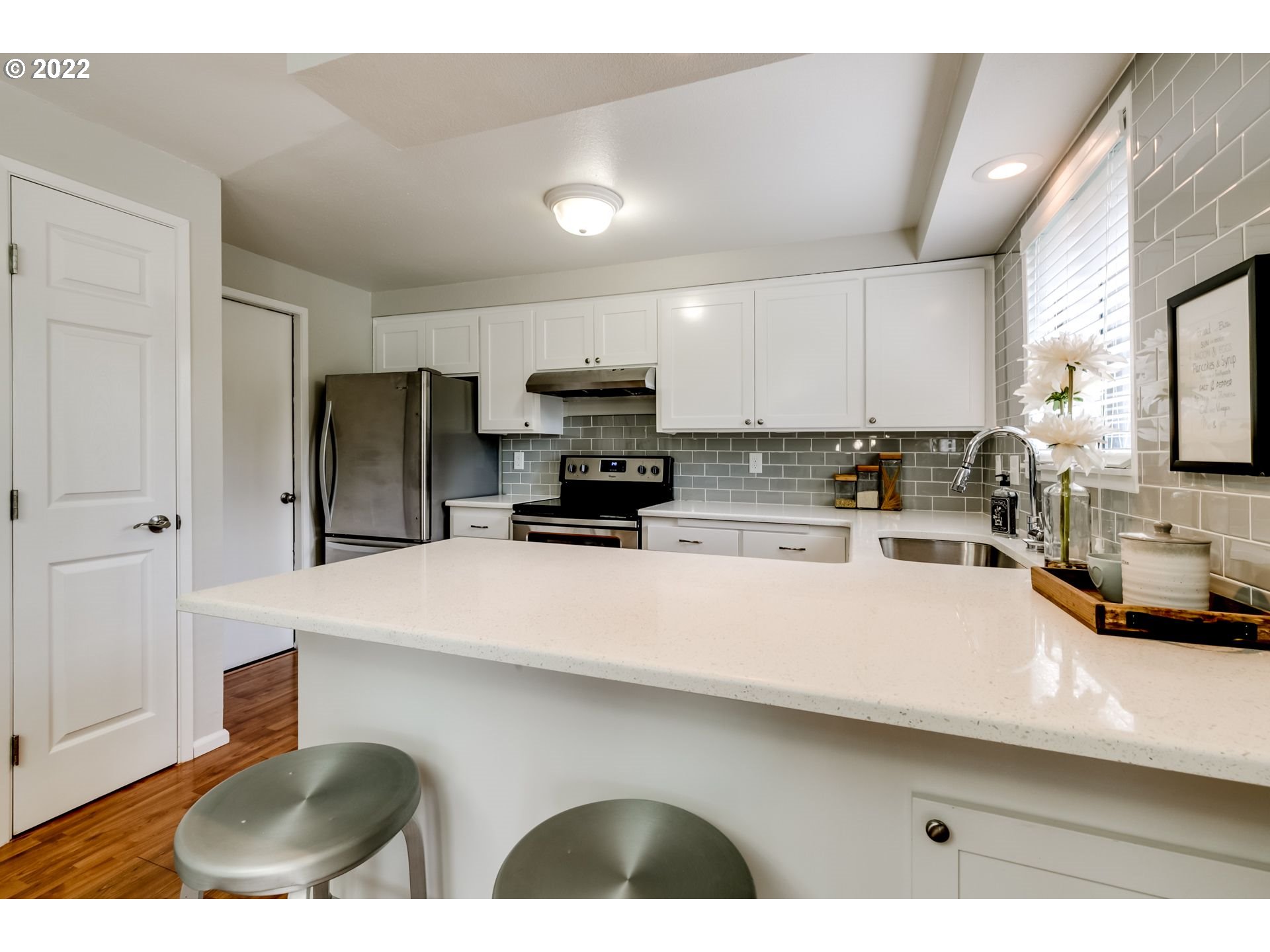 610 67th Place Springfield, OR 97478 - Photo 4 of 28 a kitchen with stainless steel appliances a refrigerator sink and microwave