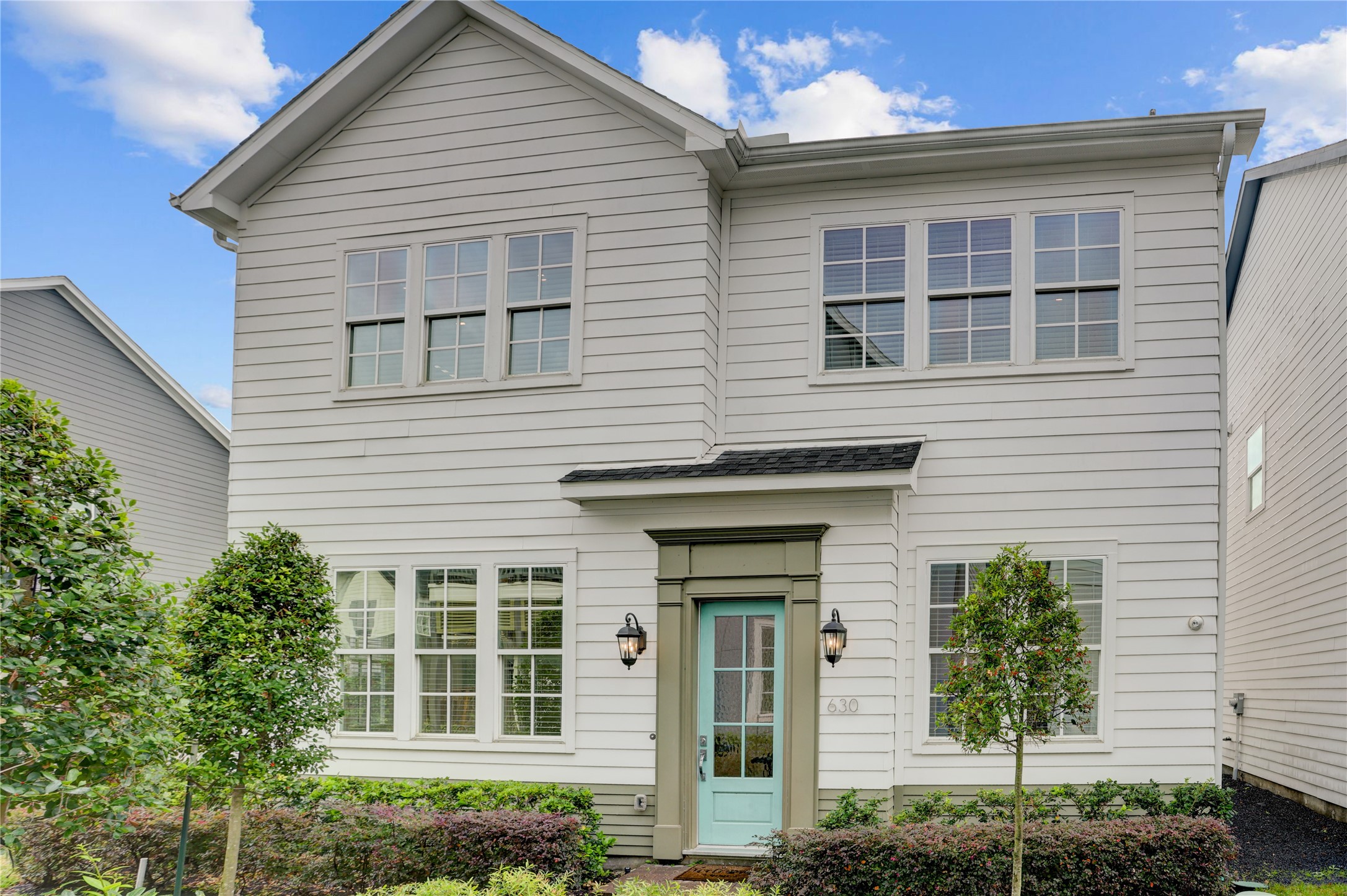 a view of a house with large windows and a yard