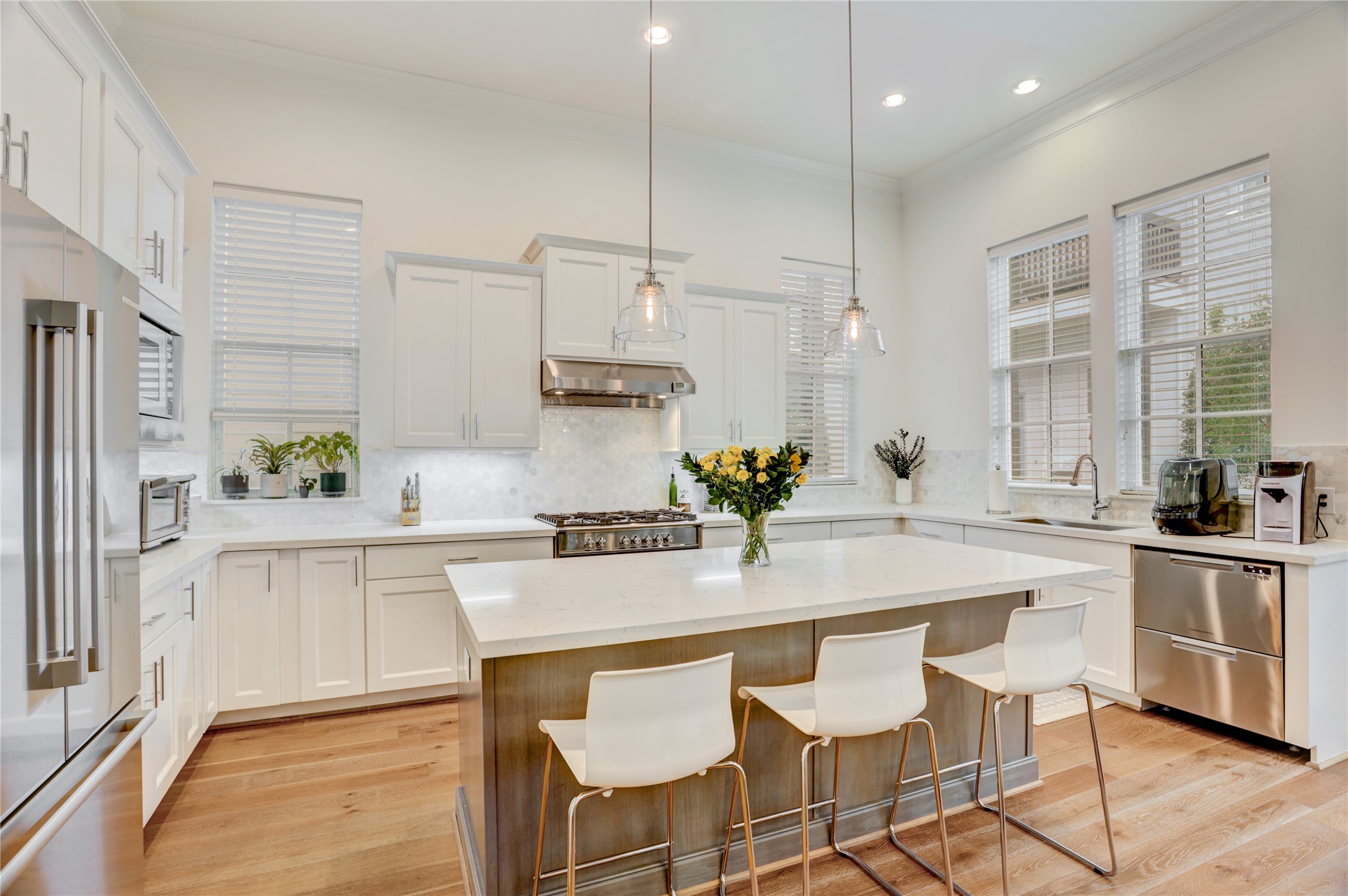 630 Delmar Street Houston, TX 77023 - Photo 6 of 27 a kitchen with kitchen island granite countertop a sink and white cabinets