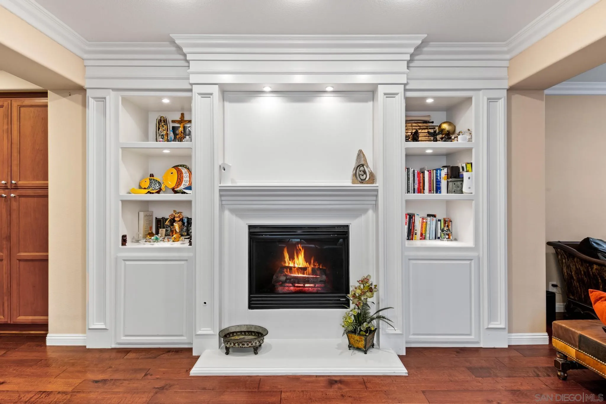 30 Long Fellow Irvine, CA 92620 - Photo 22 of 43 a living room with a fireplace and a book shelf