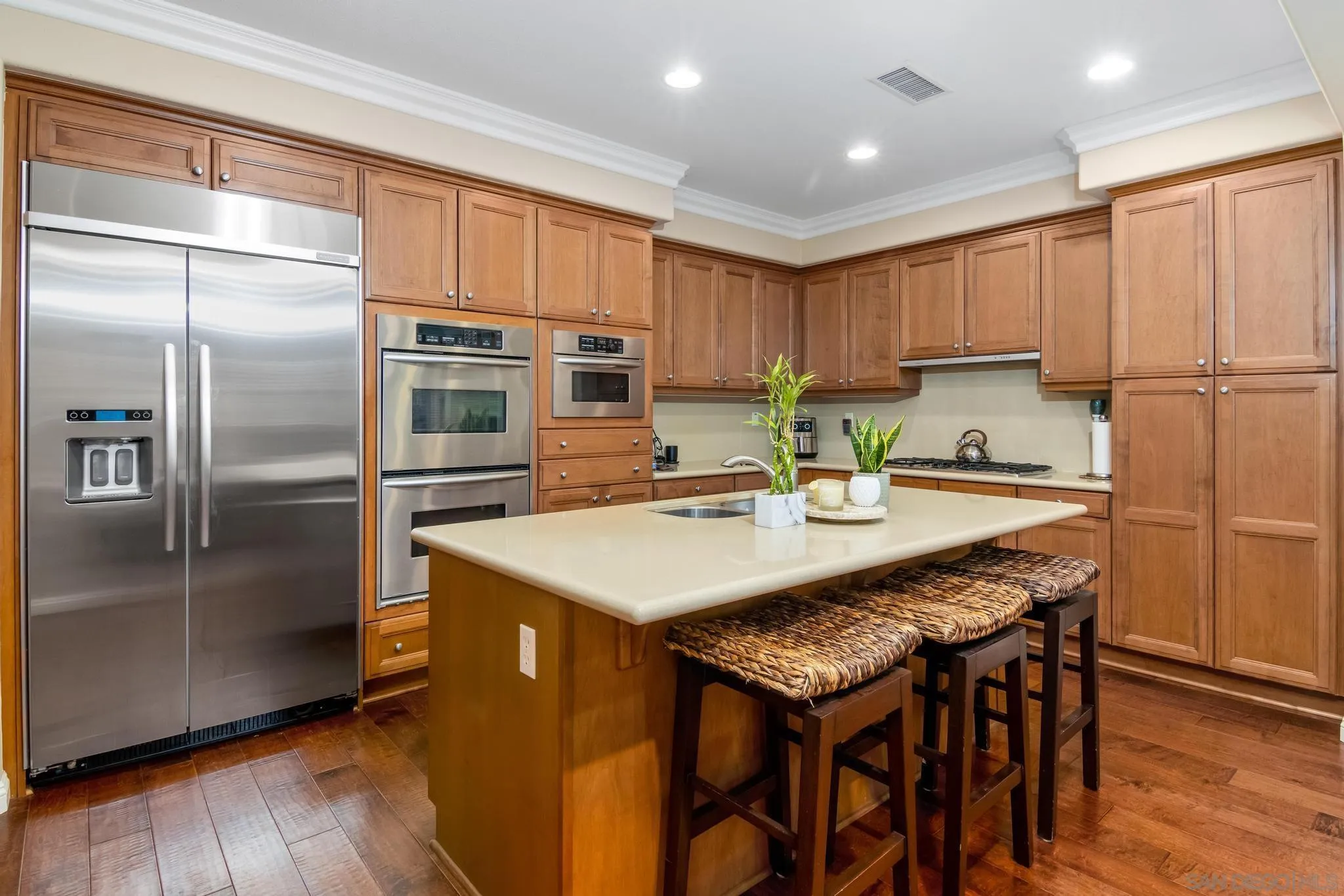 30 Long Fellow Irvine, CA 92620 - Photo 25 of 43 a kitchen with stainless steel appliances granite countertop a kitchen island a stove a refrigerator a sink a dining table and chairs