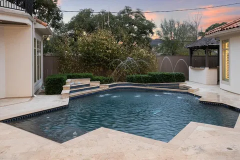 a view of a swimming pool with a yard
