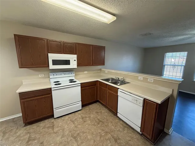 a kitchen with a stove and a microwave