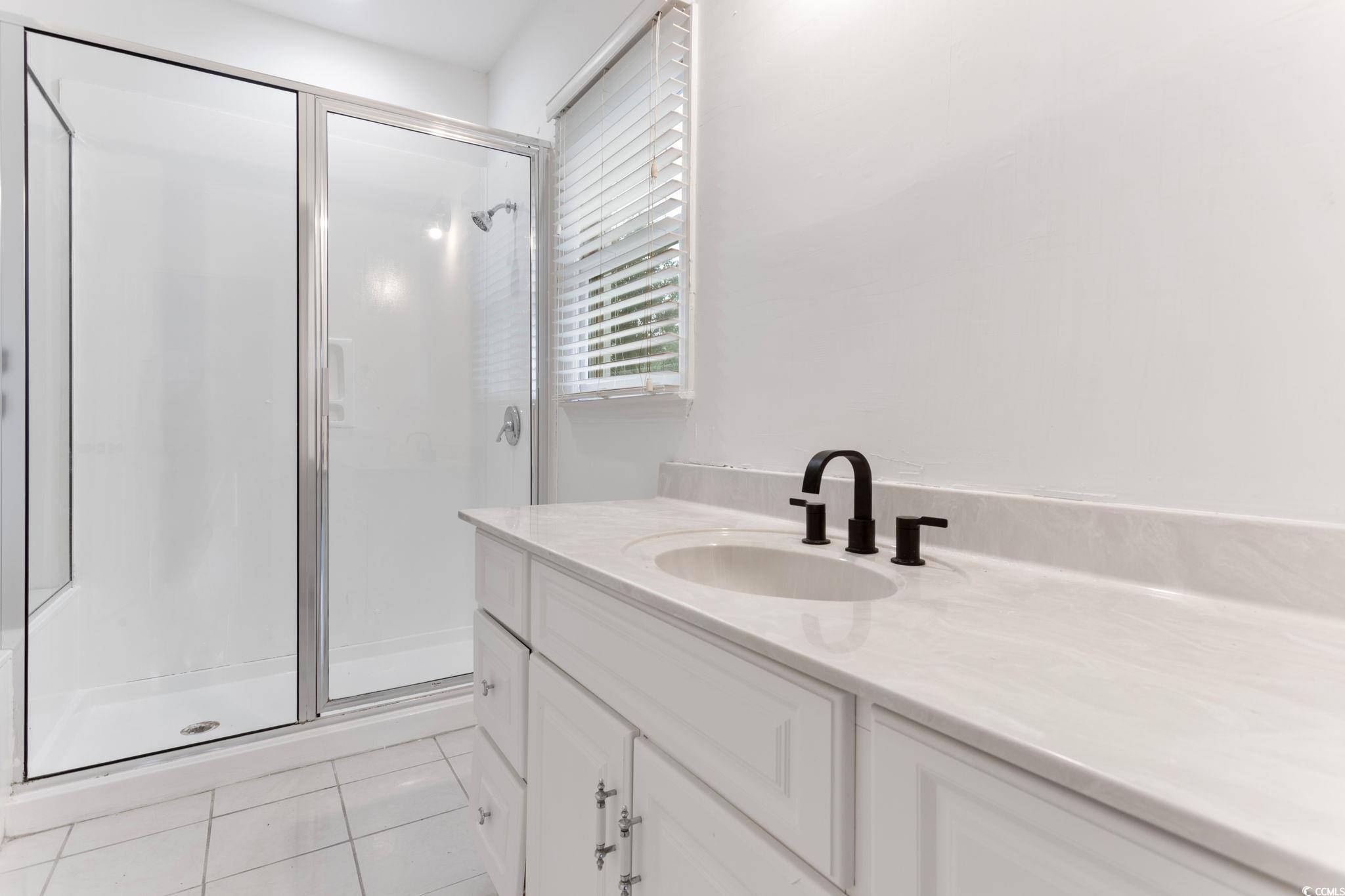 2321 Brick Drive Longs, SC 29568 - Photo 23 of 40 Full bath featuring light tile patterned flooring, a shower stall, and vanity