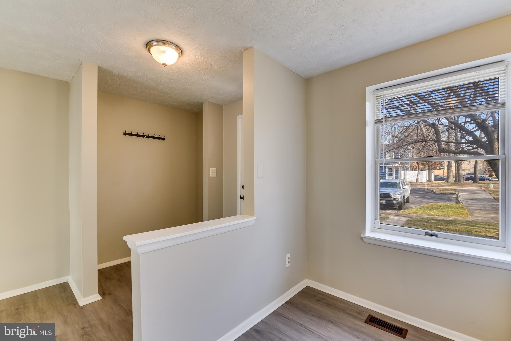 7946 Sutherland Court Pasadena, MD 21122 - Photo 12 of 37 a view of a small space with wooden floor and a window