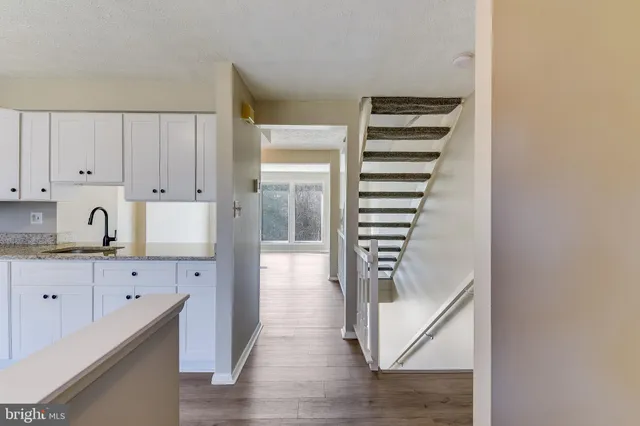 a picture of a bench in front of a wall