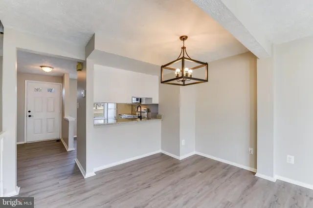 a view of a big room with kitchen and windows