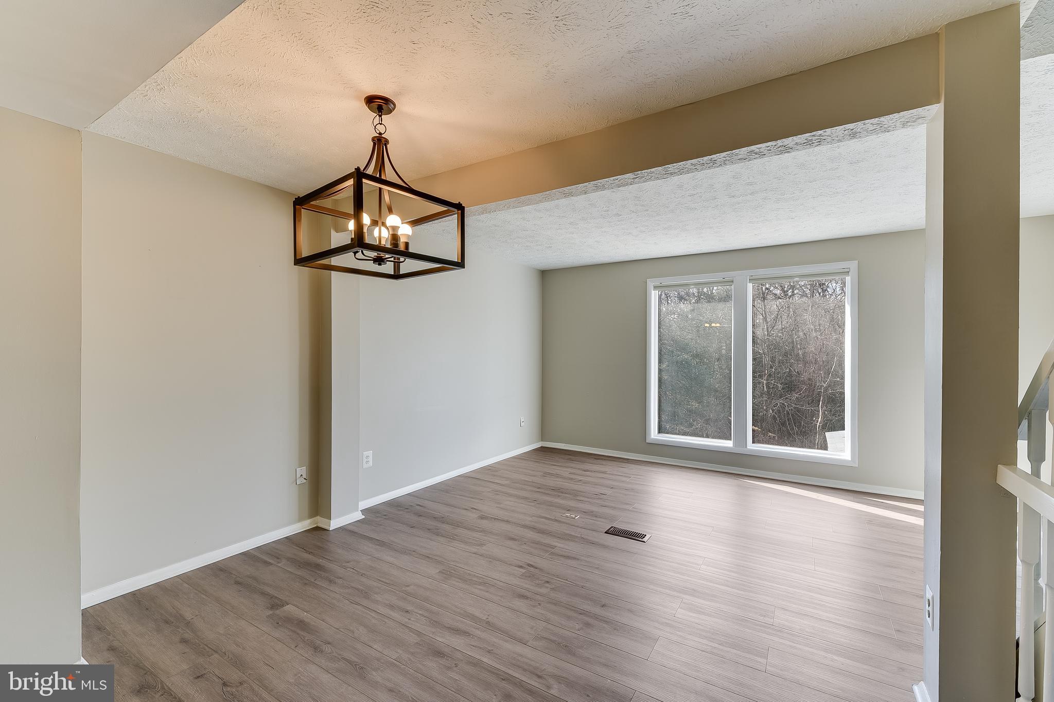 7946 Sutherland Court Pasadena, MD 21122 - Photo 15 of 37 a view of an empty room with wooden floor and a window