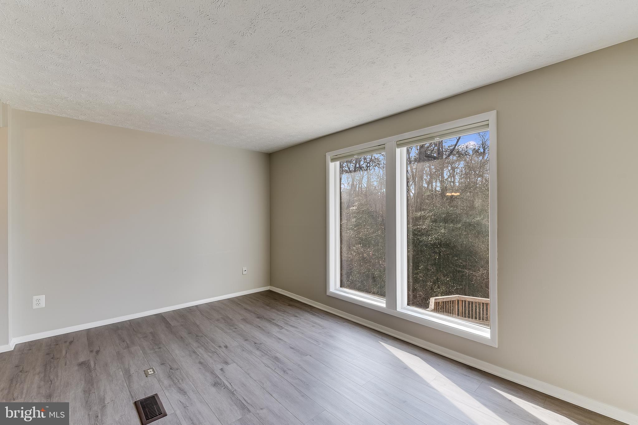 7946 Sutherland Court Pasadena, MD 21122 - Photo 16 of 37 an empty room with wooden floor and windows