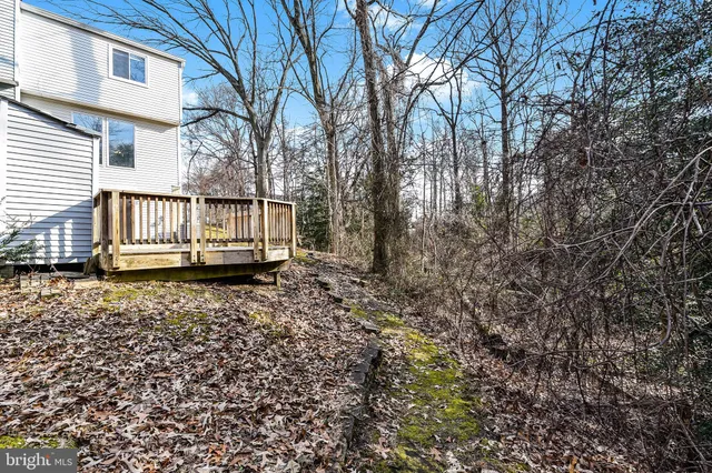 a kitchen with stainless steel appliances granite countertop a refrigerator sink and white cabinets