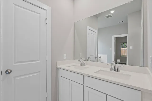 a bathroom with 2 sink and a mirror
