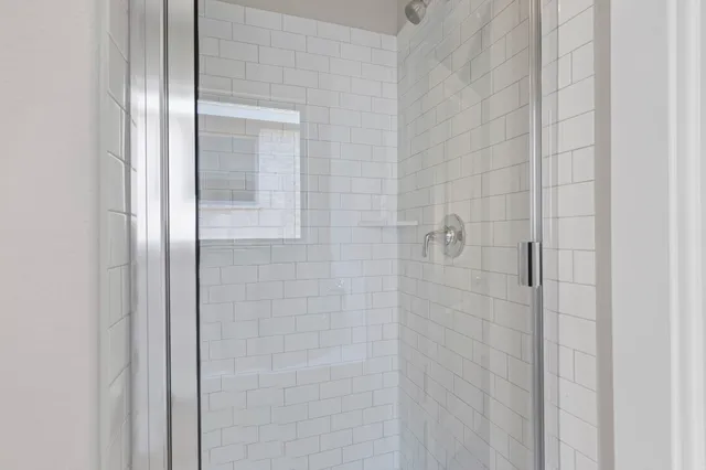a bathroom with a glass shower door