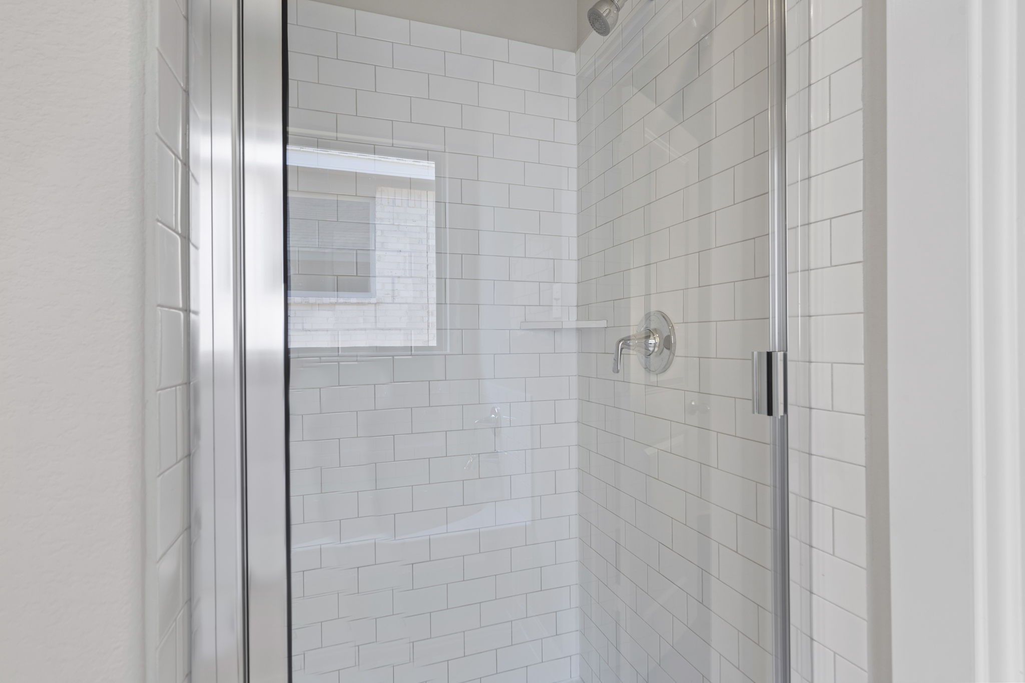 12339 Ridge Top Drive Conroe, TX 77304 - Photo 17 of 29 a bathroom with a glass shower door