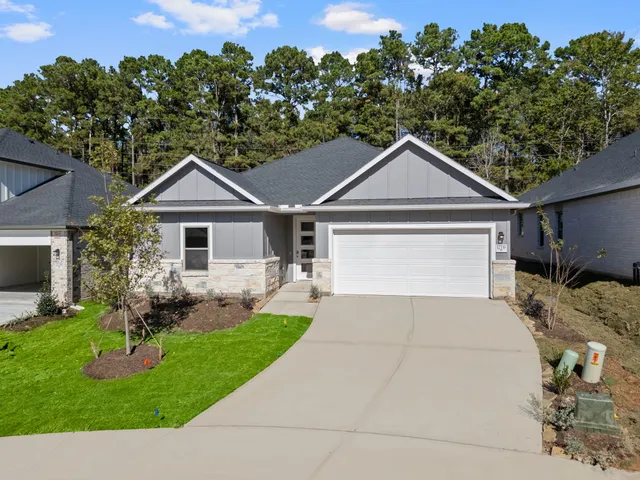 a front view of a house with a garden and plants