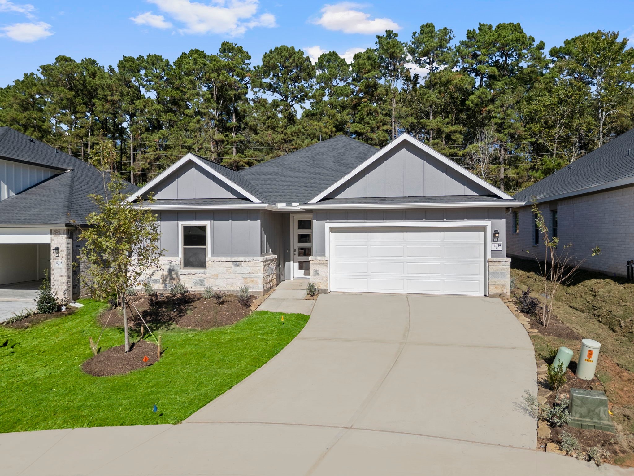 12339 Ridge Top Drive Conroe, TX 77304 - Photo 25 of 29 a front view of a house with a garden and plants