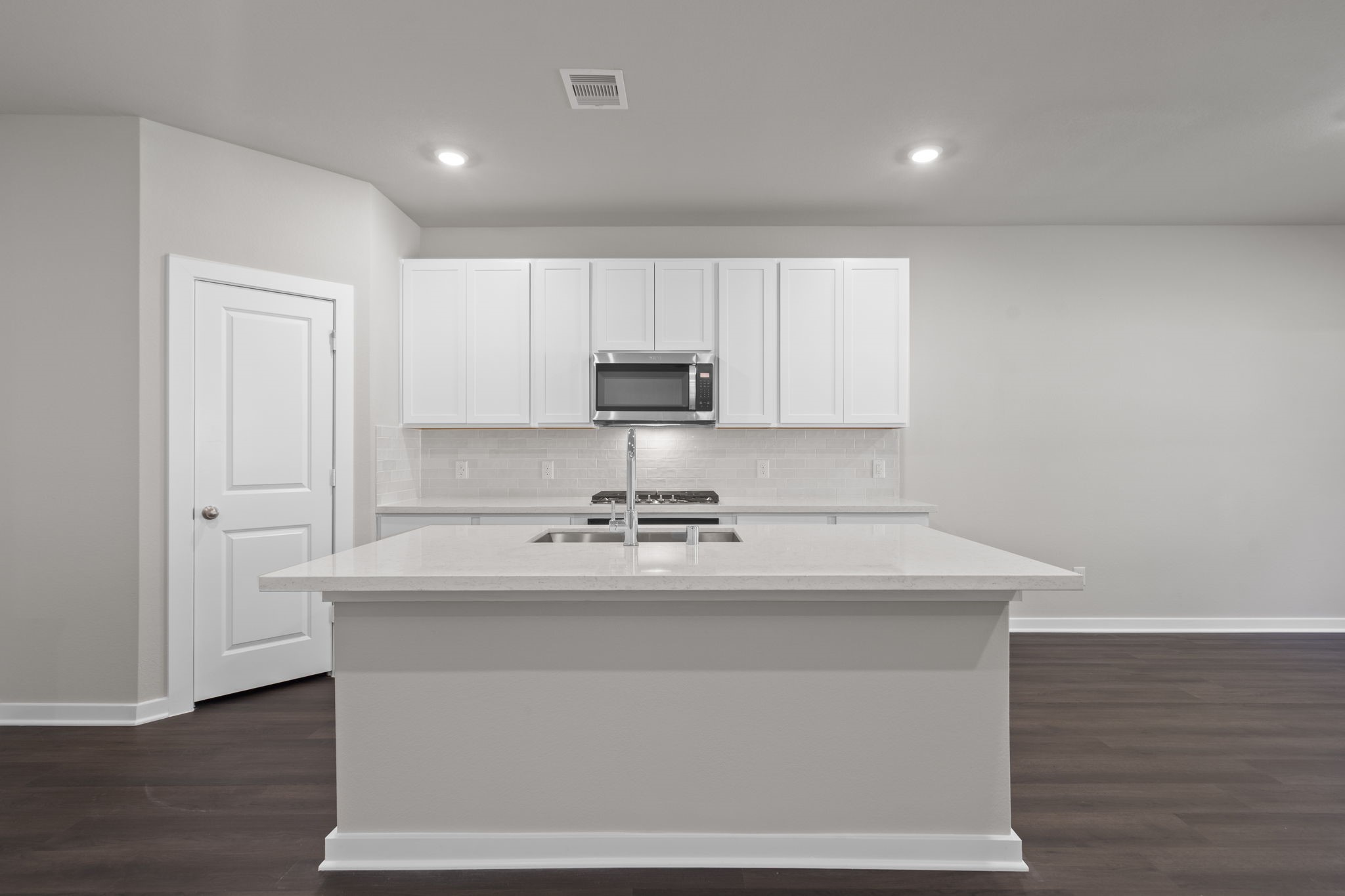 12339 Ridge Top Drive Conroe, TX 77304 - Photo 3 of 29 a kitchen with kitchen island a sink and a stove top oven