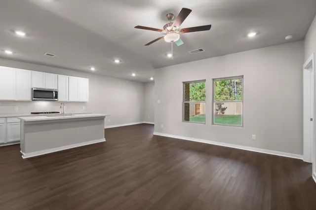 an open kitchen view with wooden floor and a window